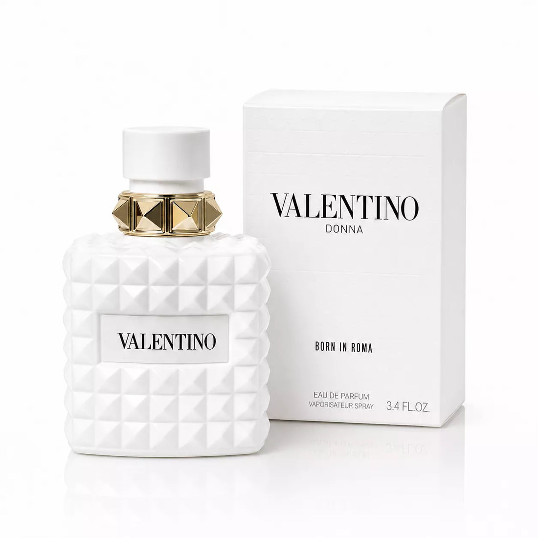 Valentino Donna Born in Roma Ivory Eau de Parfum bottle next to its white packaging box, featuring a white textured geometric design and a gold pyramid accent on the cap.